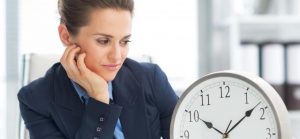 woman looking at clock waiting