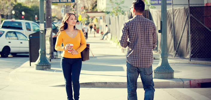 couple walking towards each other on the street