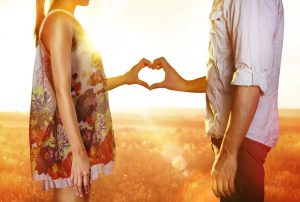 couple making a heart with their hands