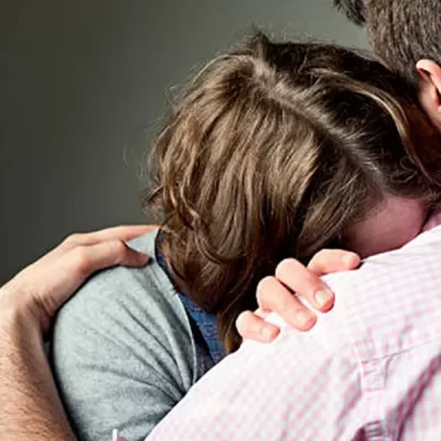 woman-crying-on-mans-shoulder