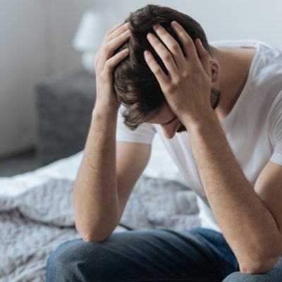 despondent-man-on-bed